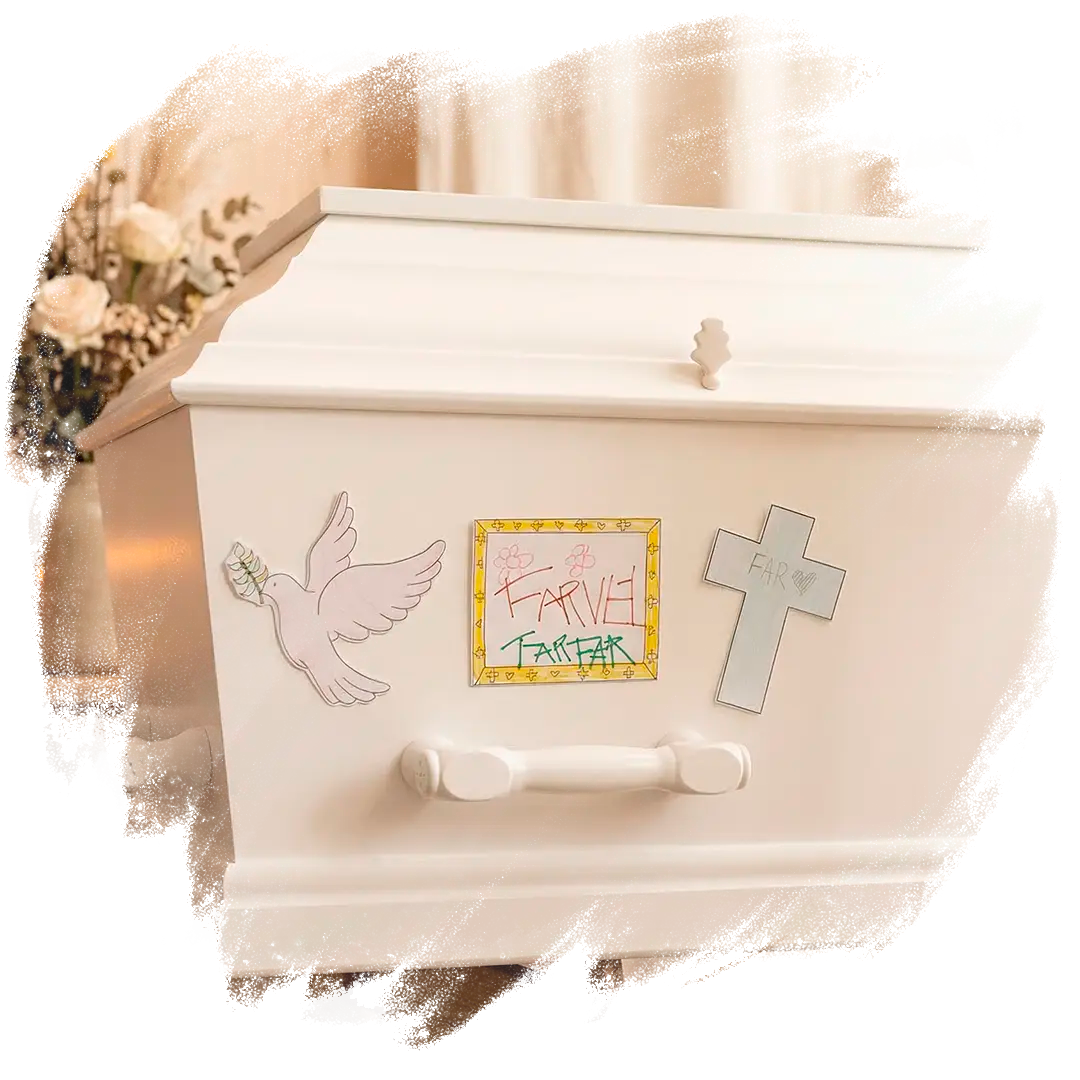 Tre farvelagte kristne mindemærkater sat på en kiste. 